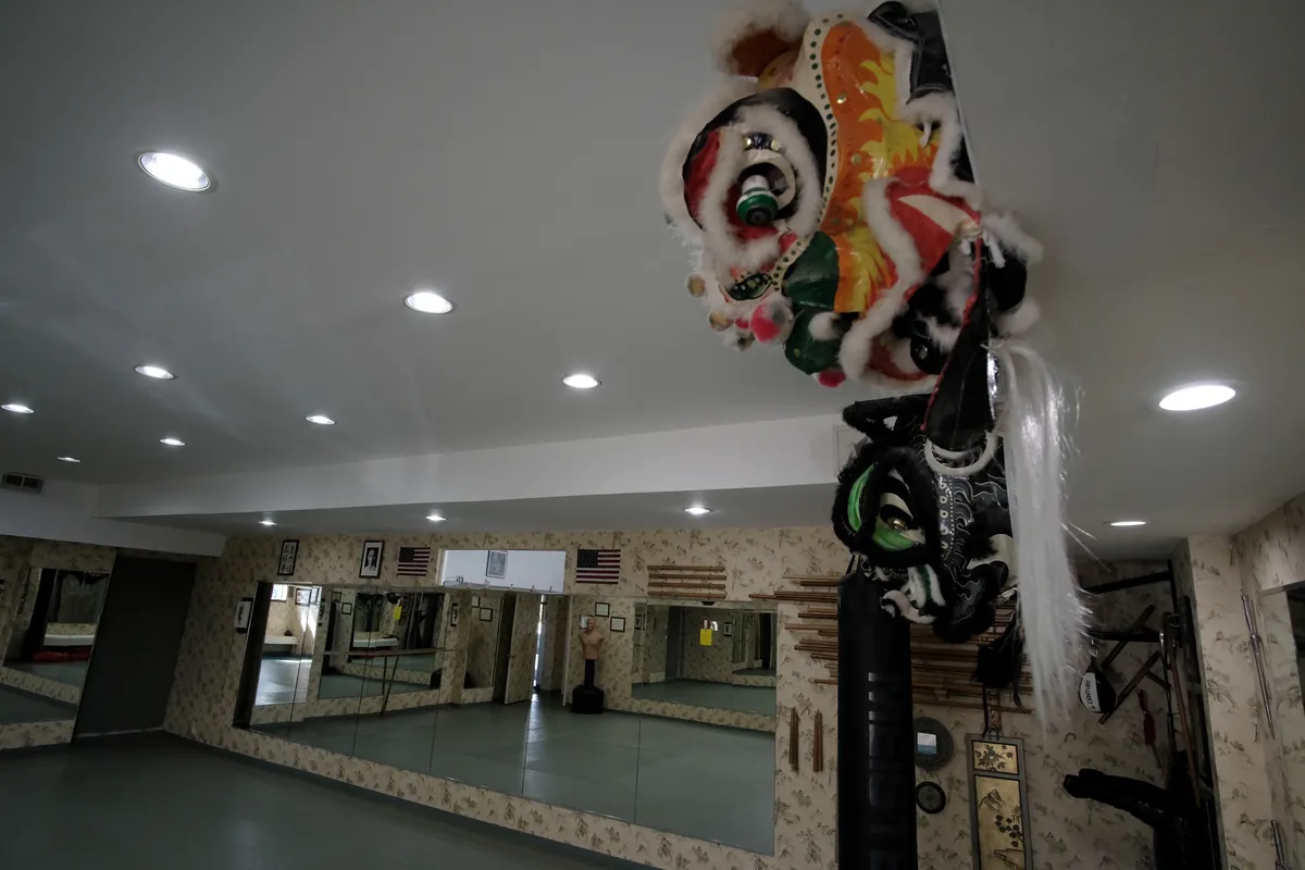 The matted karate dojo with mirrors along the wall