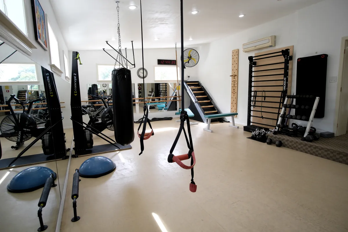 Heavy bag, suspension straps and stall bars in the boxing area